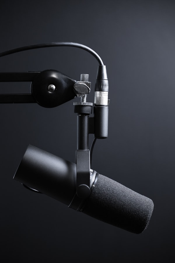Persona usando auriculares frente a un micrófono en una sala insonorizada